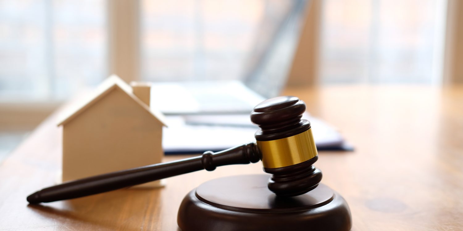 judge gavel & house model at courtroom. estate law & property auction concept