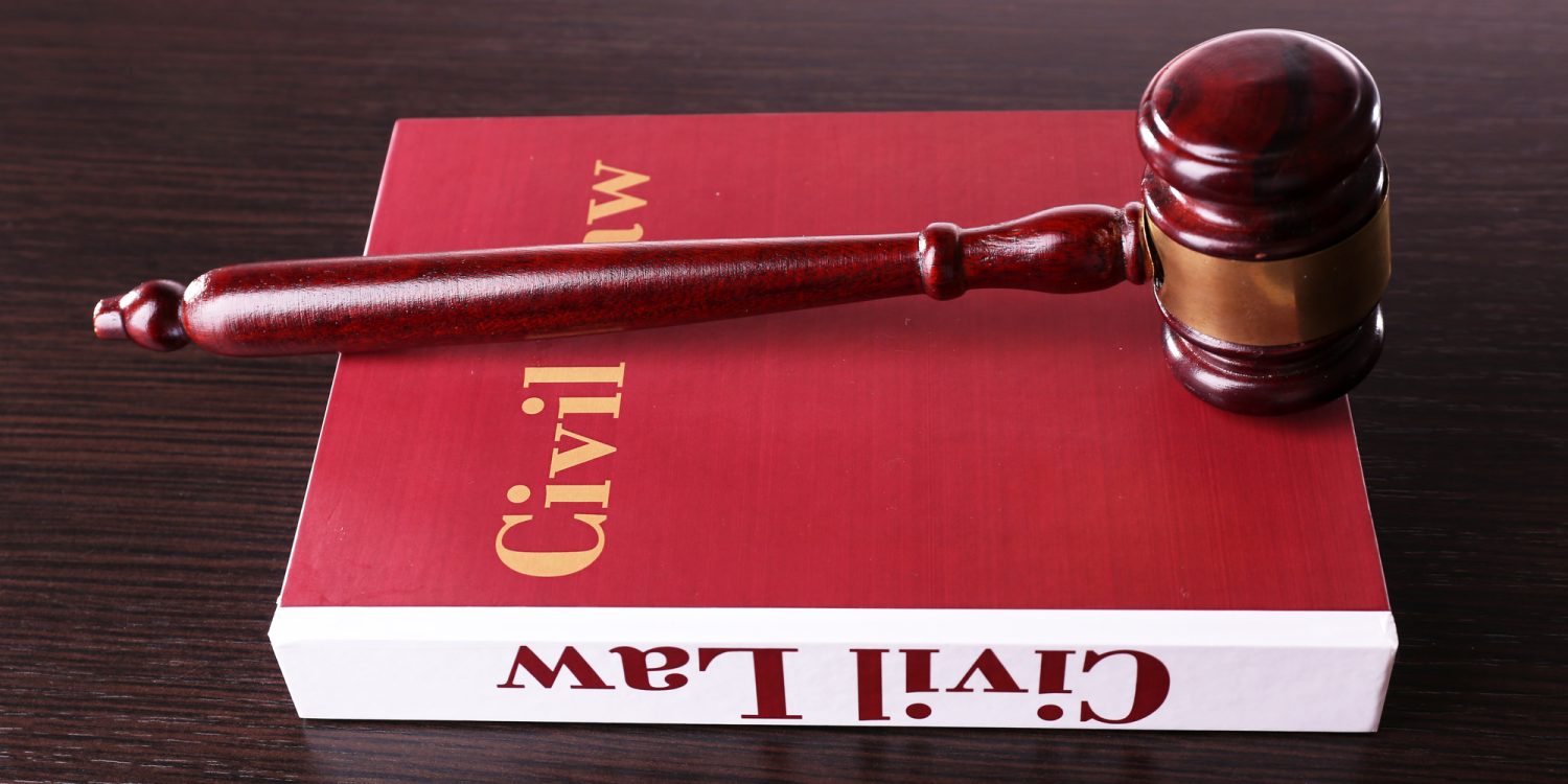 Civil Law book with hammer on wooden table